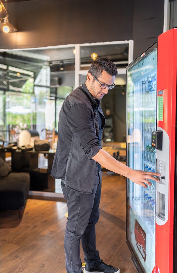 Person selecting item from vending machine