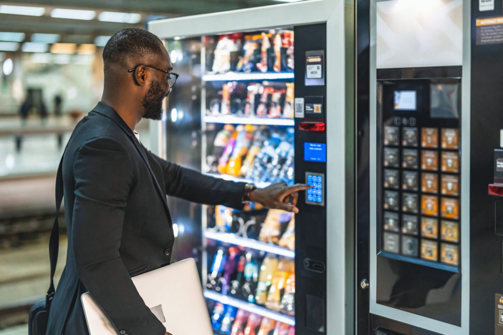 Businessman selecting snacks from vending machine